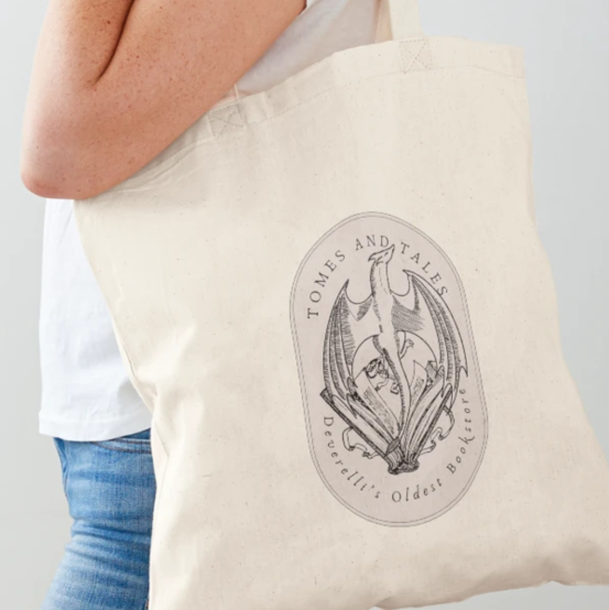Tales and Tomes logo on a tote bag